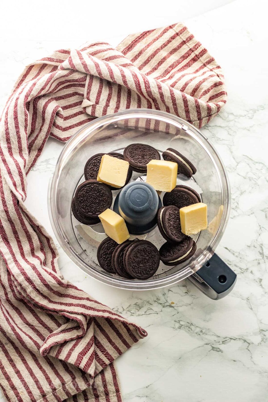 Unblended oreos and butter in food processor. 