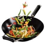 A wok with veggies in
