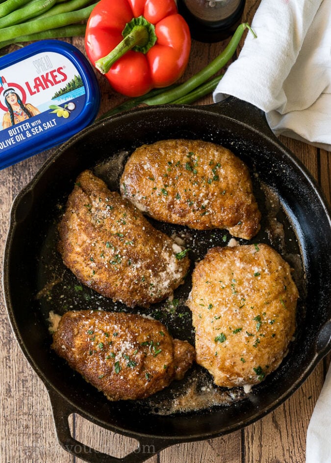 Sear the pork chops in a cast iron skillet before baking them in the oven.